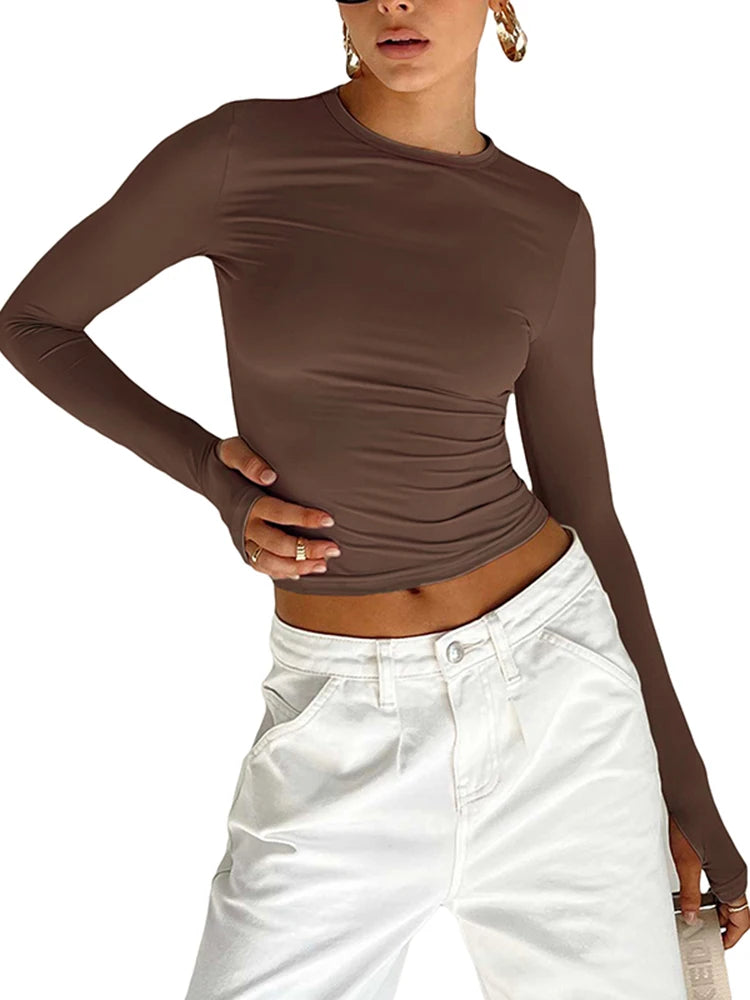 Fitted long-sleeve crop top with a round neckline and thumbholes – simple, stylish, and perfect for casual streetwear looks.