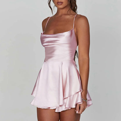 Kurzer Satin-Jumpsuit mit Wasserfallausschnitt, Spaghettiträgern und Rückenschnürung – leicht, elegant und ideal für warme Tage oder lange Nächte.