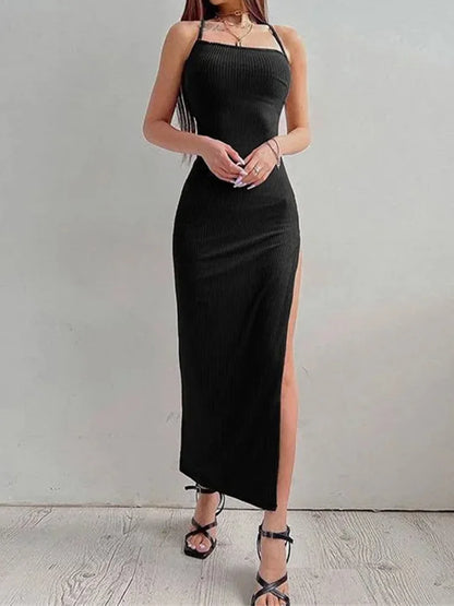 Abito maxiforma nero con spacco alto, spalline sottili e collo a halter – senza schiena, aderente e ideale per eleganti serate estive.