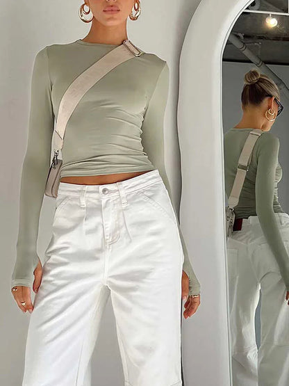 Fitted long-sleeve crop top with a round neckline and thumbholes – simple, stylish, and perfect for casual streetwear looks.