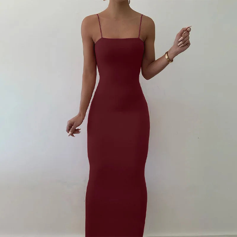 Black bodycon dress with spaghetti straps and back cutout – sleeveless, figure-hugging, and ideal for club or streetwear.